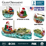 Santa's Fishing Adventure Glass Christmas Ornament, Holiday Angler Fish in Sleigh