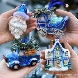 A Marvelous Blue Christmas Set of Four Glass Ornaments with Santa, Truck, Snow Cabin and Sleigh