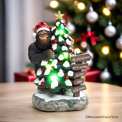 Whimsical Bigfoot Behind Christmas Tree Figurine, 7.5" Funny Holiday Yeti LED Statue, He Sees You When You're Sleeping